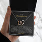 Hand holding the black and gold To My Daughter card from Dad with the Interlocking Hearts necklace in a black gift box