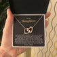 Hand presenting the open gift box with the black and gold To My Daughter card from Dad and two linked heart pendants