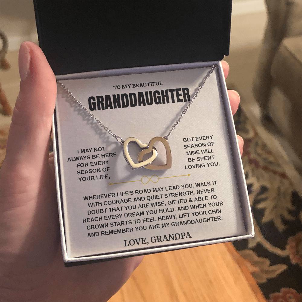 Open gift box with the Love, Grandpa granddaughter card and linked hearts necklace held up in warm indoor light