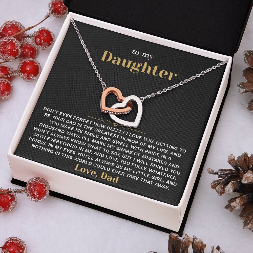 Black and gold To My Daughter card from Dad with the Interlocking Hearts necklace in a white gift box with red berries and pinecones