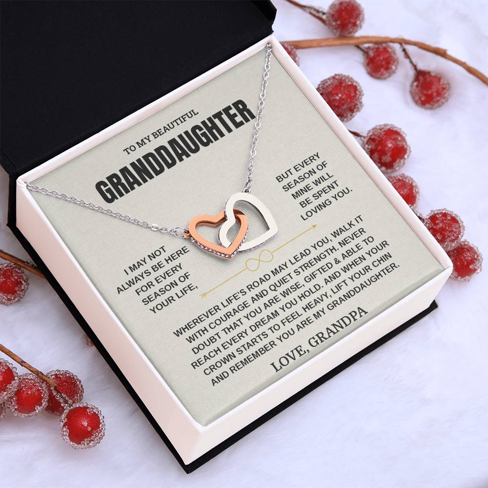 Tilted white gift box with the Love, Grandpa granddaughter card and hearts necklace among red berries