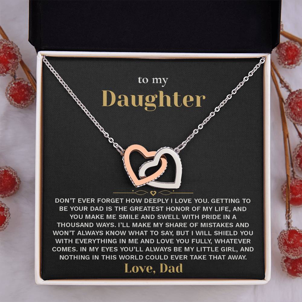 Black and gold To My Daughter card from Dad with the Interlocking Hearts necklace in a gift box beside red berries