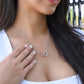 Woman touching the Interlocking Hearts pendant at her neckline