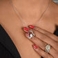 Hand with a ring holding the Forever Love heart pendant at the neck (To My Bonus Daughter set)