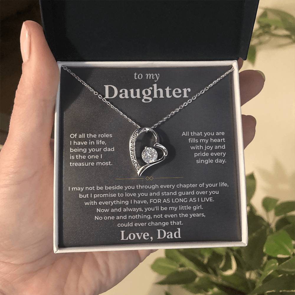 Hand holding an open black gift box with the charcoal To My Daughter card from Dad and heart pendant