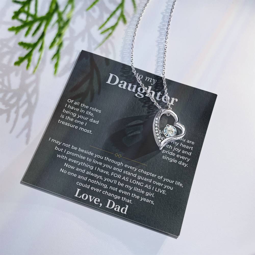 Charcoal To My Daughter card from Dad with heart necklace laid flat beside a pine sprig