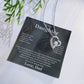 Charcoal To My Daughter card from Dad with heart necklace laid flat beside a pine sprig