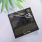 Forever Love heart necklace on the black and gold To My Daughter card from Dad with green leaves, white background
