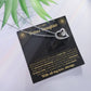 Forever Love heart necklace on the black and gold To My Bonus Daughter card with green leaves, white background