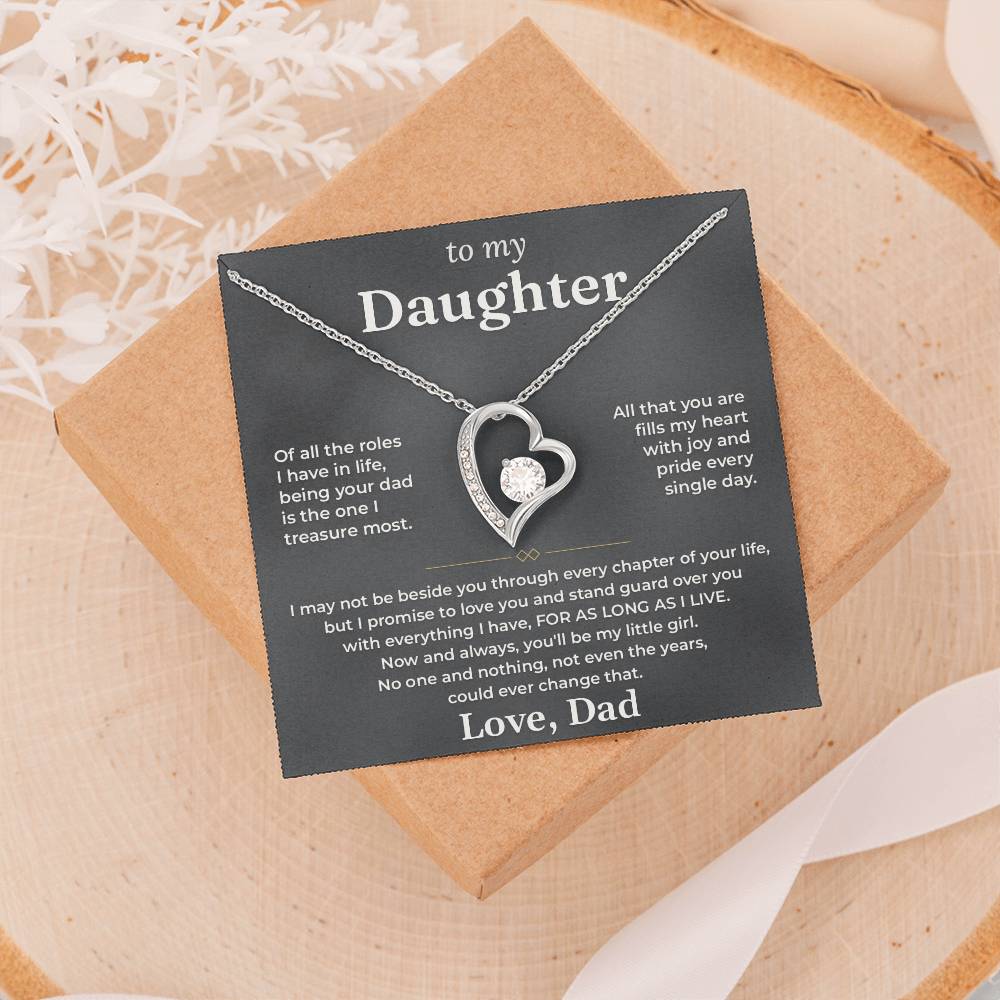 Charcoal To My Daughter card from Dad and heart necklace on a gift box resting on a wood slice with dried flowers