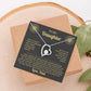 Black and gold To My Daughter card from Dad with Forever Love necklace on a wood slice beside greenery