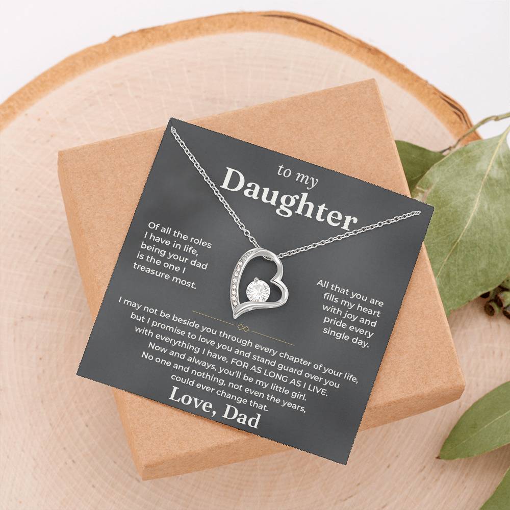 Charcoal To My Daughter card from Dad with Forever Love necklace on a wood slice beside greenery