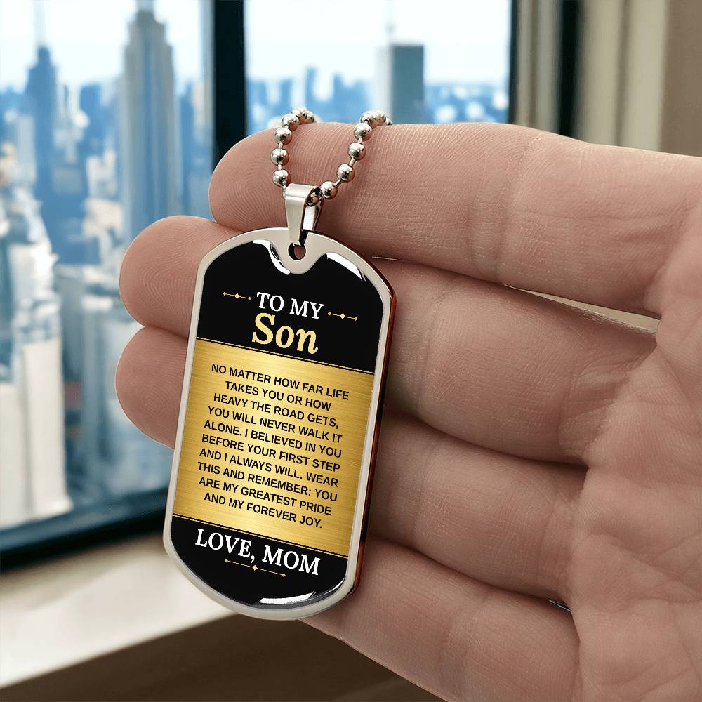 To My Son Necklace from Mom – silver dog tag held in hand to show size