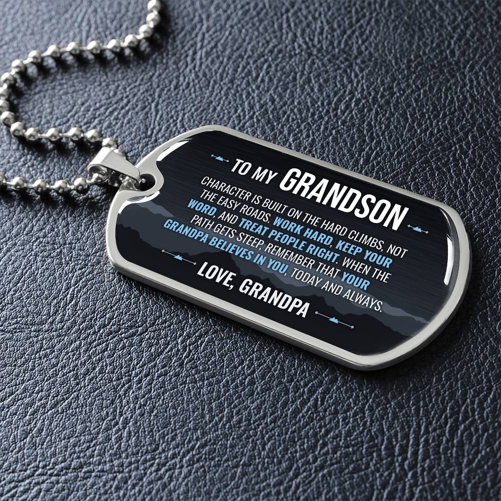 To My Grandson Necklace from Grandpa – dog tag necklace laid flat on a dark background