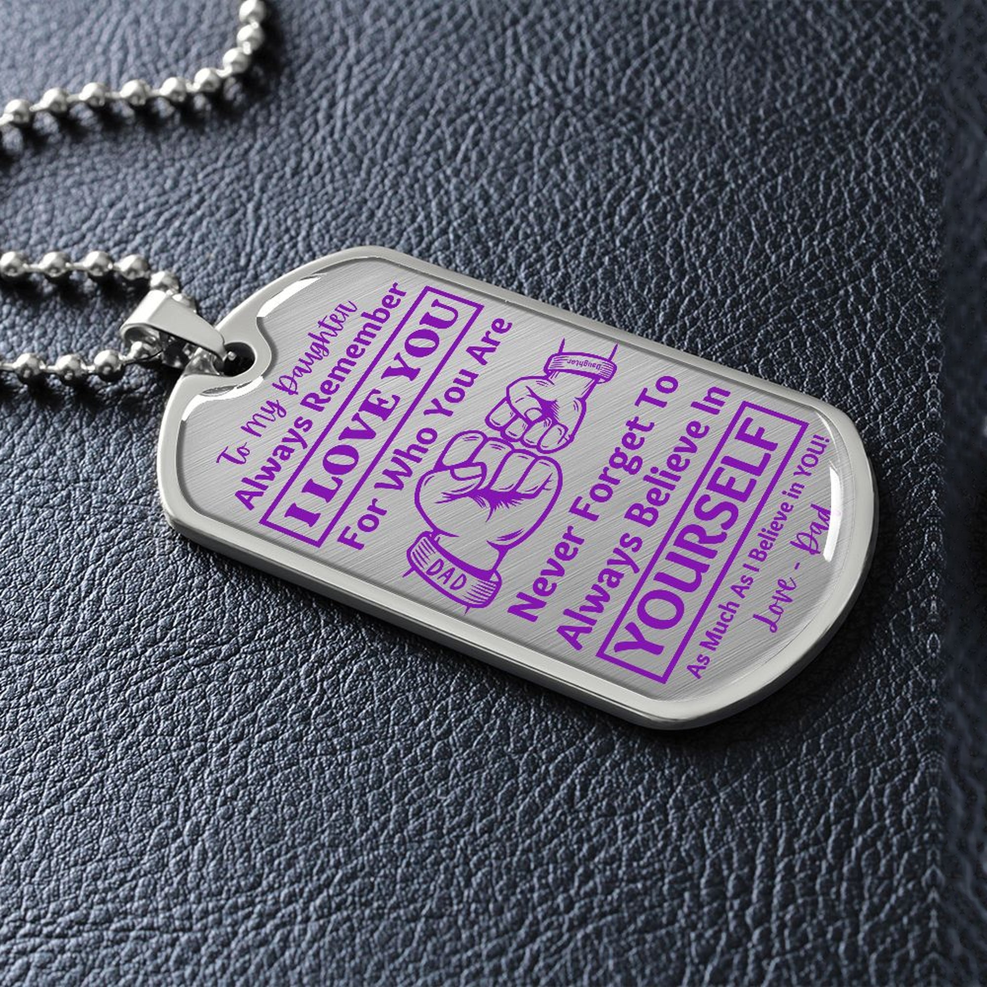 Silver I Love You Daughter dog tag lying on black leather