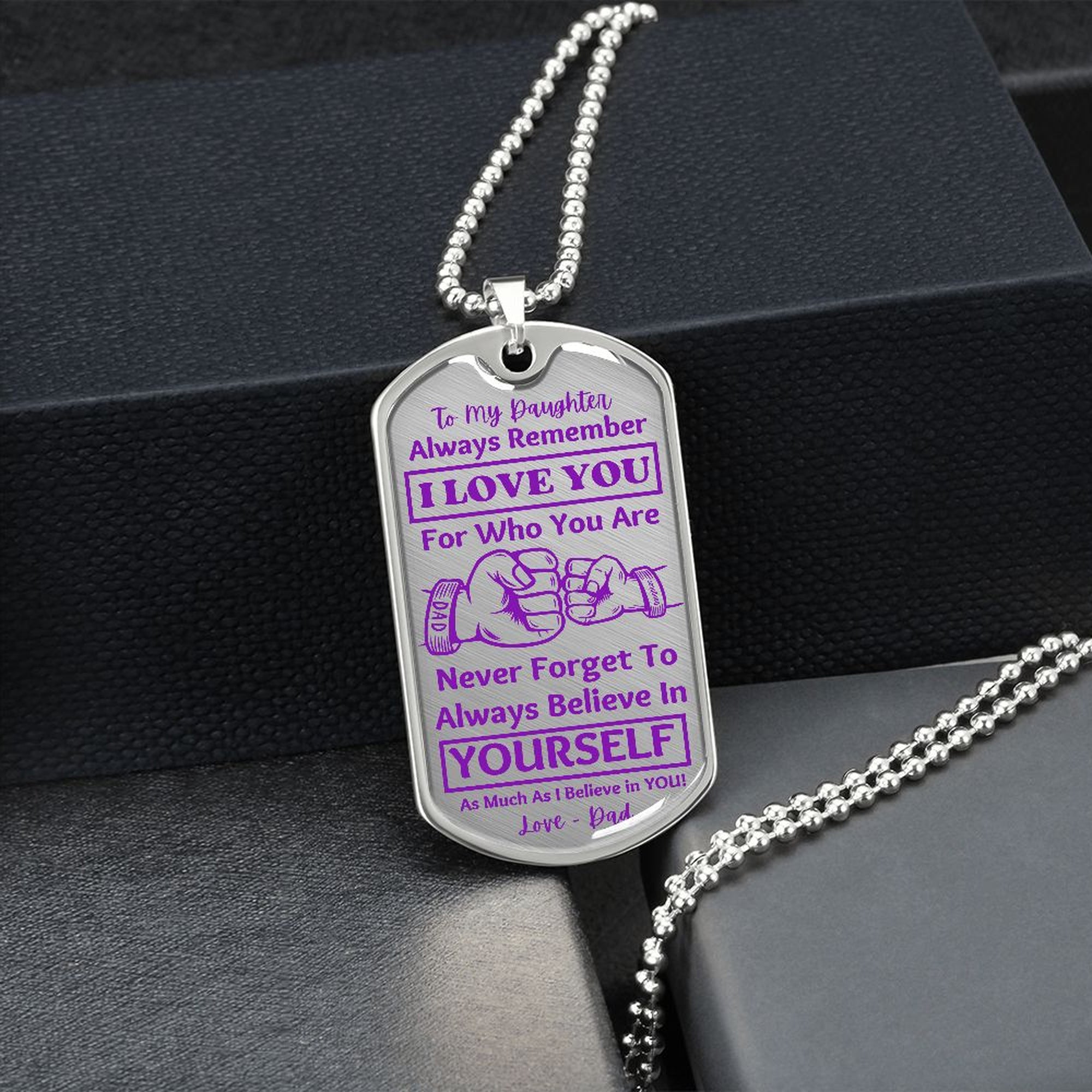 Silver I Love You Daughter dog tag hanging over a black gift box