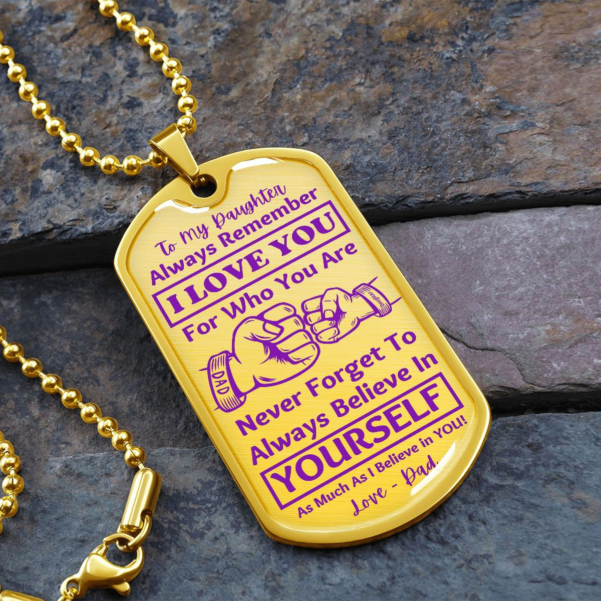 Gold-finish I Love You Daughter dog tag necklace on slate stone