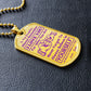 Gold-finish I Love You Daughter dog tag lying on black leather