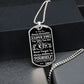 Silver Believe in Yourself son dog tag hanging over a black gift box