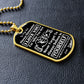 Gold-finish Believe in Yourself son dog tag lying on black leather