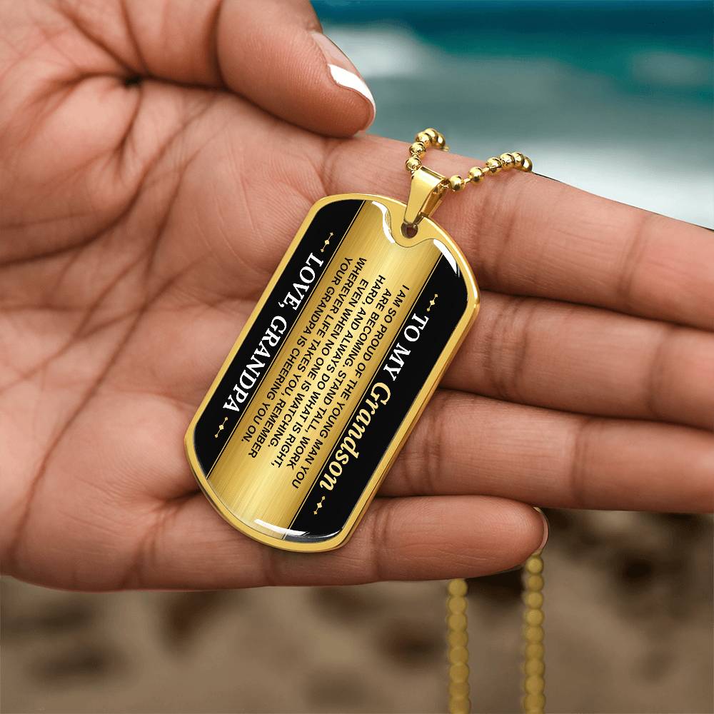 To My Grandson Necklace from Grandpa – gold dog tag held in hand to show size