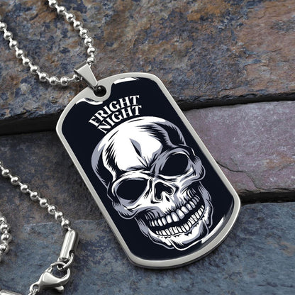 Fright Night skull dog tag necklace in silver on a ball chain, resting on slate stone