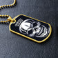 Gold-finish Fright Night skull dog tag lying on black leather