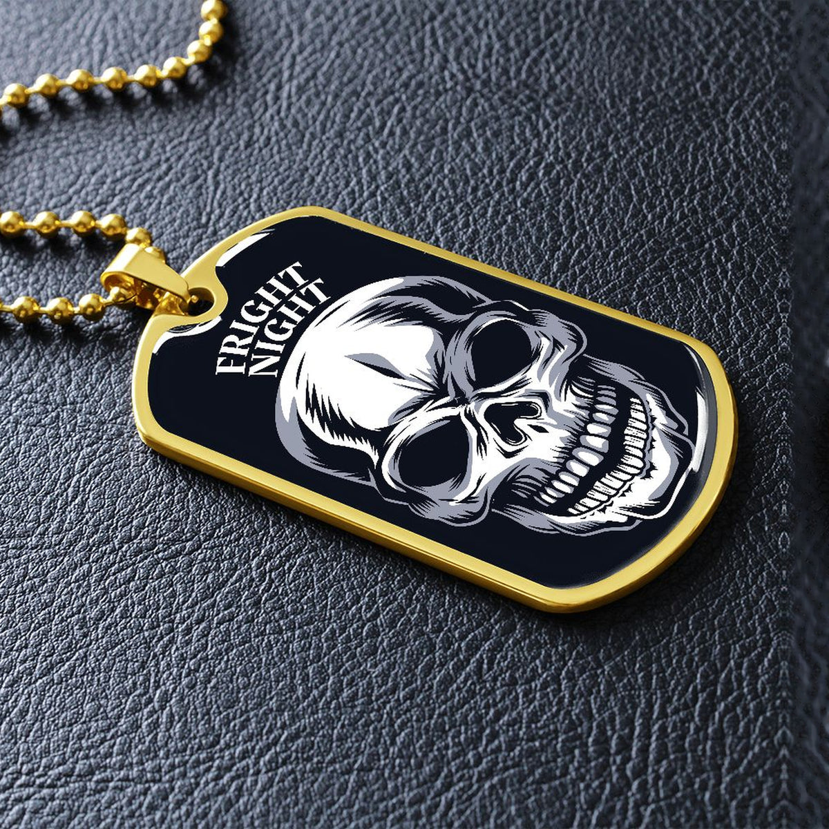 Gold-finish Fright Night skull dog tag lying on black leather