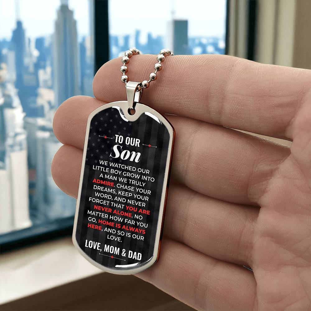 To Our Son Necklace from Mom & Dad – silver dog tag held in hand to show size