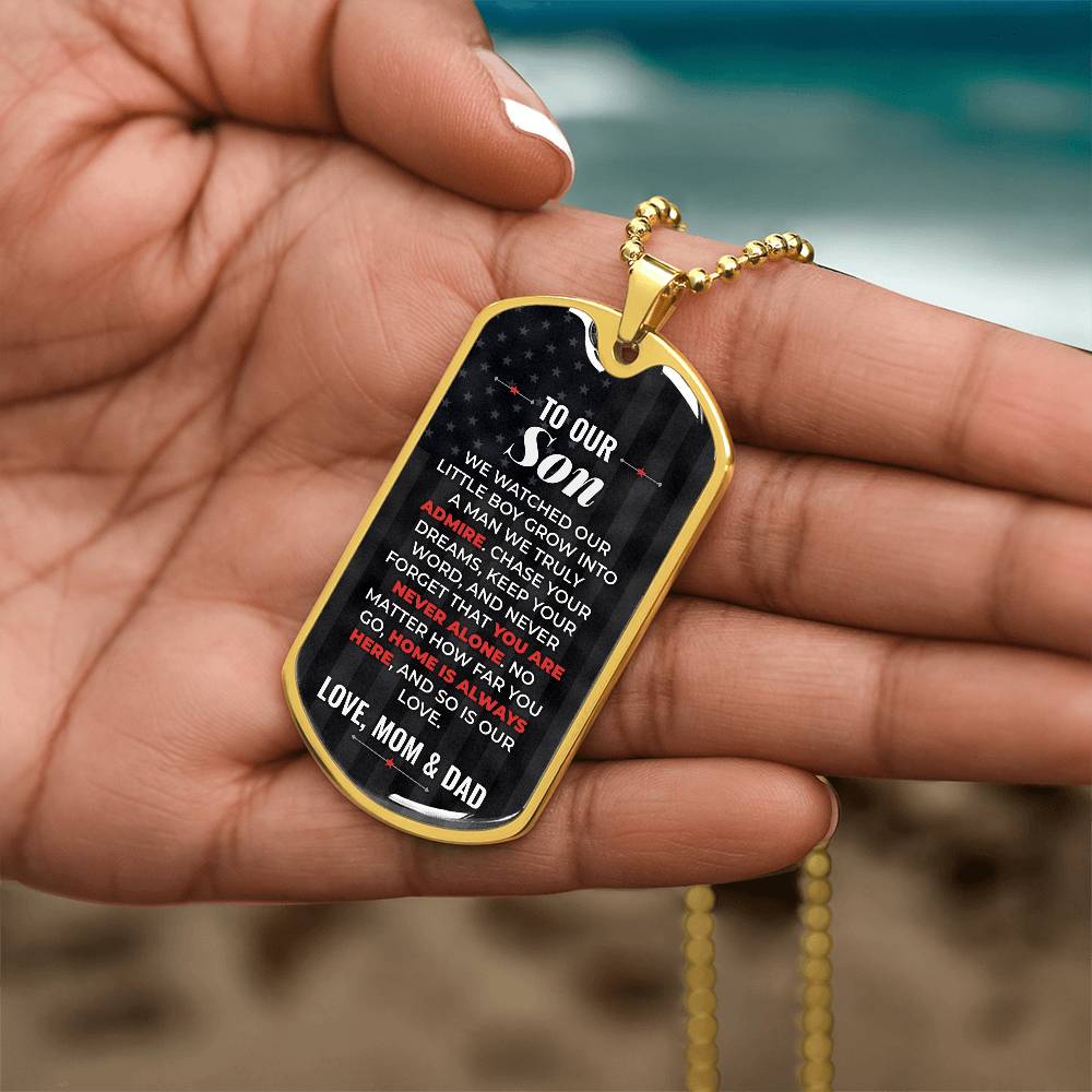 To Our Son Necklace from Mom & Dad – gold dog tag held in hand to show size