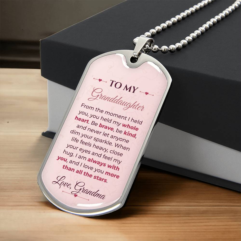 To My Granddaughter Necklace from Grandma – silver dog tag necklace resting on a gift box