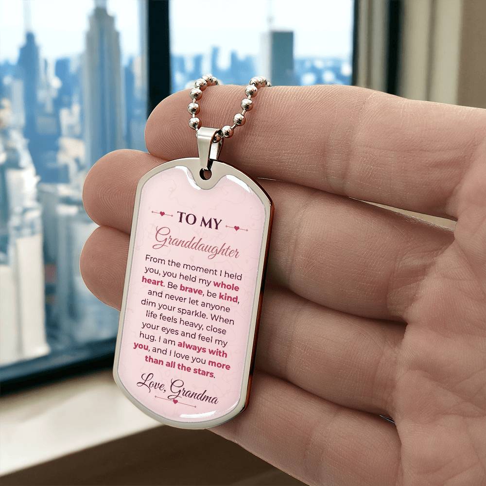 To My Granddaughter Necklace from Grandma – silver dog tag held in hand to show size