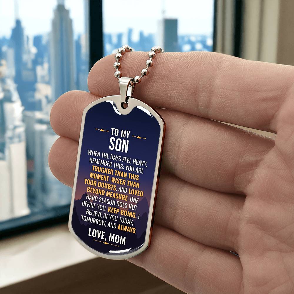 To My Son Necklace from Mom – silver dog tag held in hand to show size