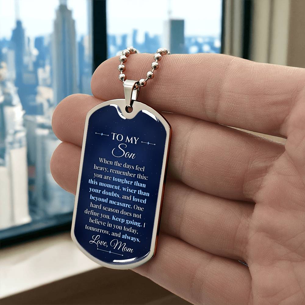 To My Son Necklace from Mom – silver dog tag held in hand to show size