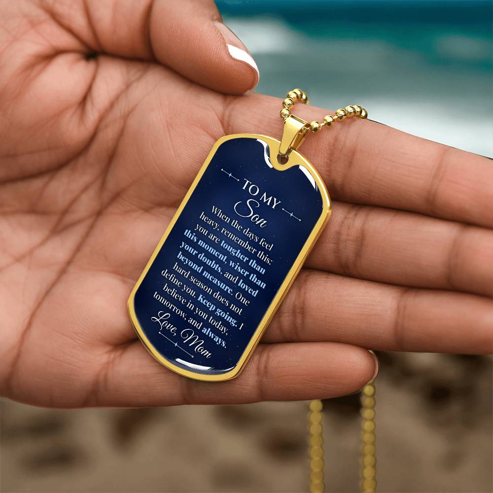 To My Son Necklace from Mom – gold dog tag held in hand to show size