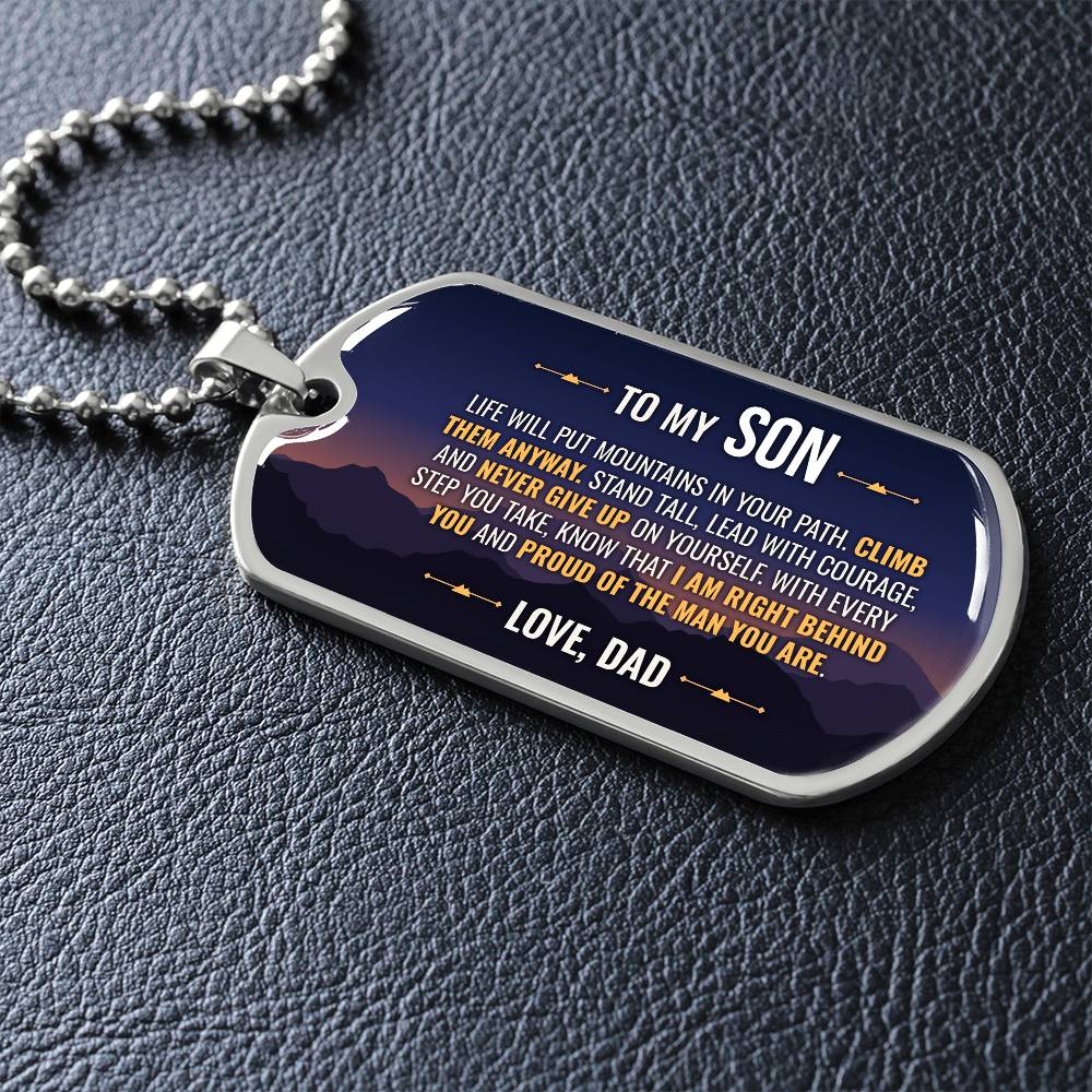 To My Son Necklace from Dad – dog tag necklace laid flat on a dark background