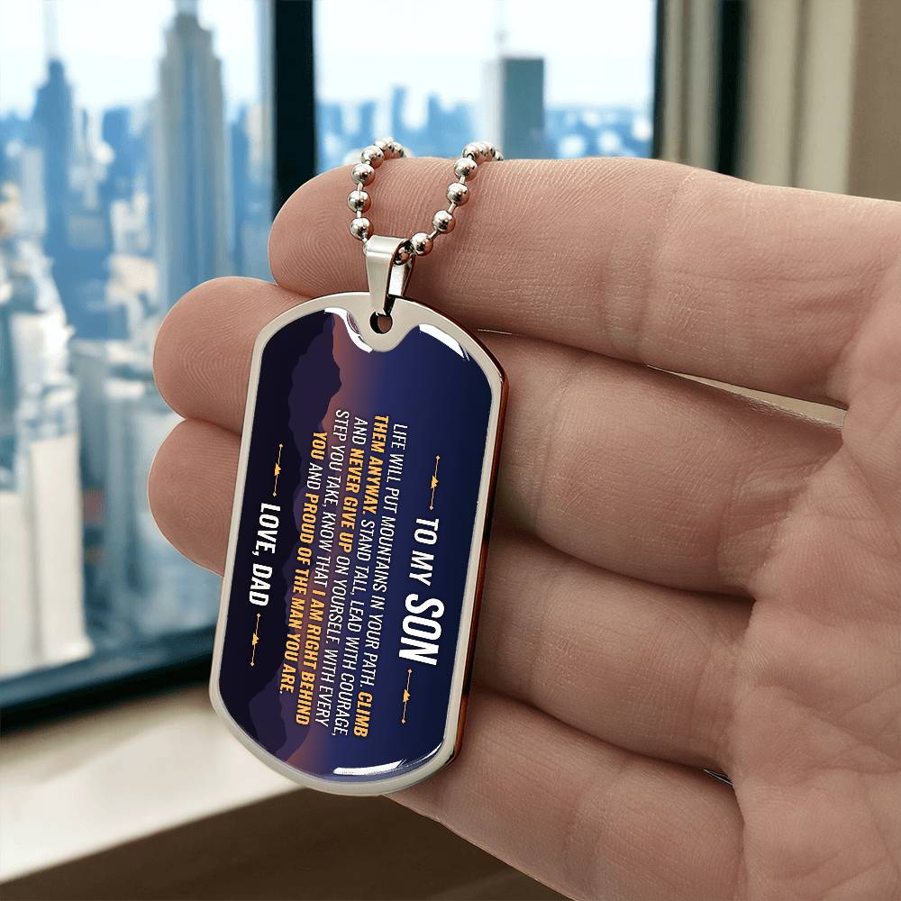 To My Son Necklace from Dad – silver dog tag held in hand to show size