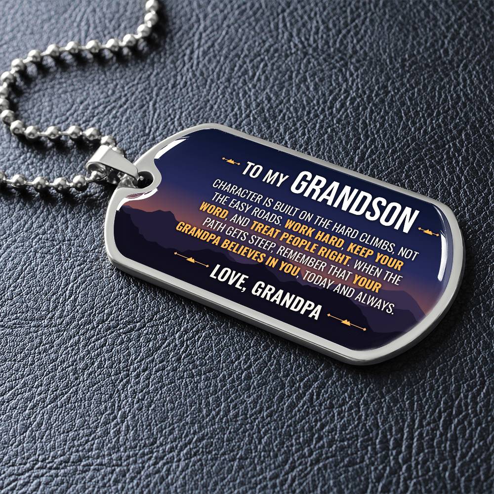 To My Grandson Necklace from Grandpa – dog tag necklace laid flat on a dark background