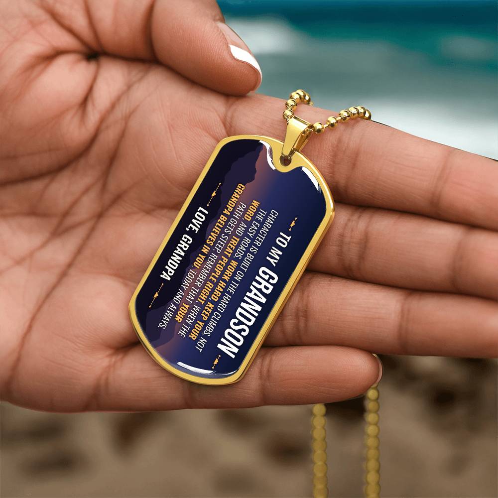 To My Grandson Necklace from Grandpa – gold dog tag held in hand to show size