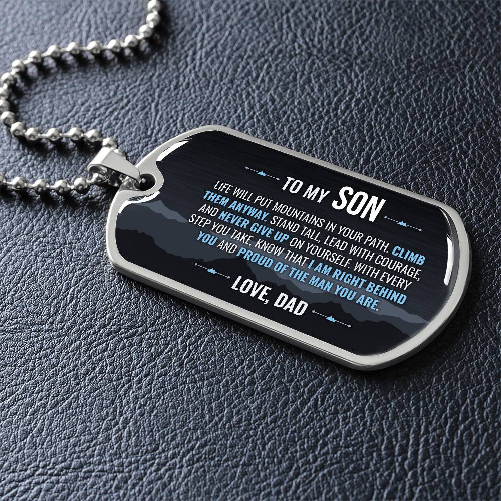 To My Son Necklace from Dad – dog tag necklace laid flat on a dark background