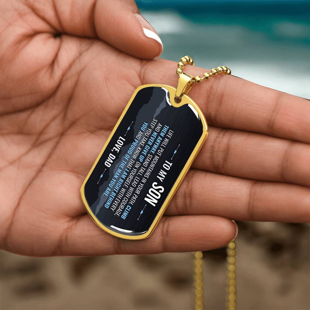 To My Son Necklace from Dad – gold dog tag held in hand to show size