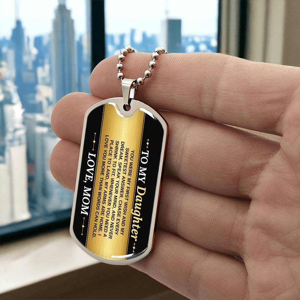 To My Daughter Necklace from Mom – silver dog tag held in hand to show size