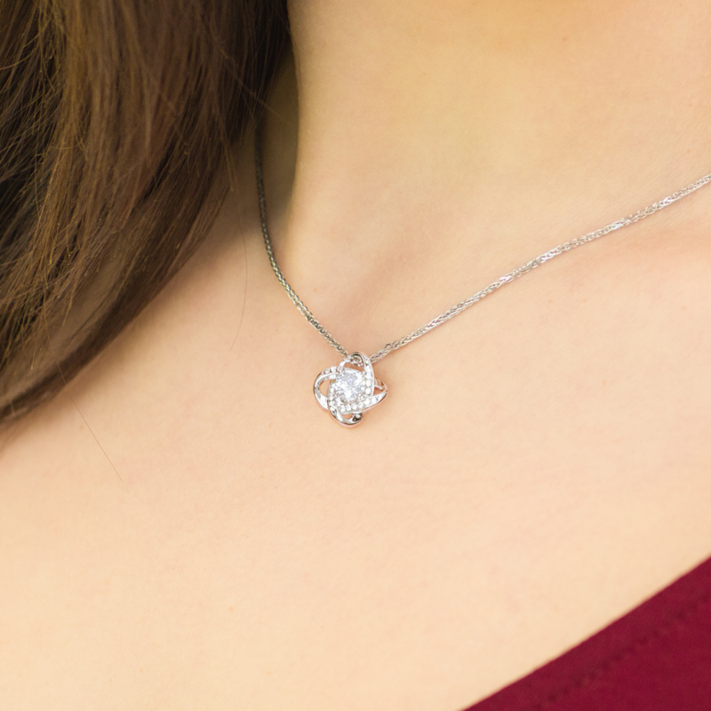 Woman wearing white gold Love Knot necklace — new mom gift lifestyle from oezzo