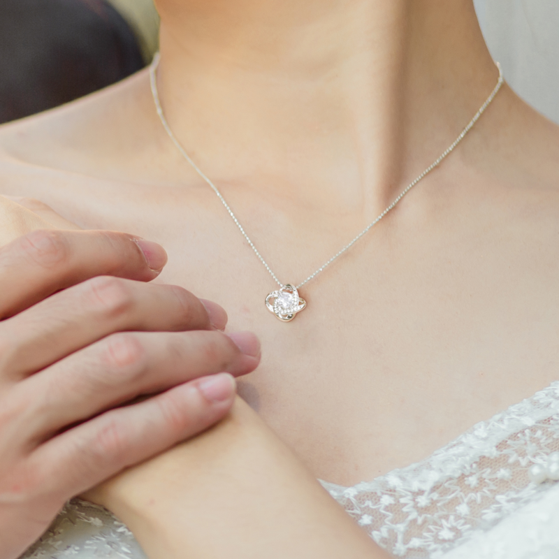 White gold Love Knot necklace worn with lace dress — congratulations new mom keepsake