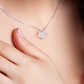 Close-up white gold Love Knot necklace at collarbone — personalized new mom jewelry oezzo
