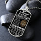 Silver Old Lion son dog tag propped on dark river rocks