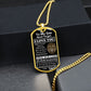Gold-finish Old Lion son dog tag hanging over a black gift box