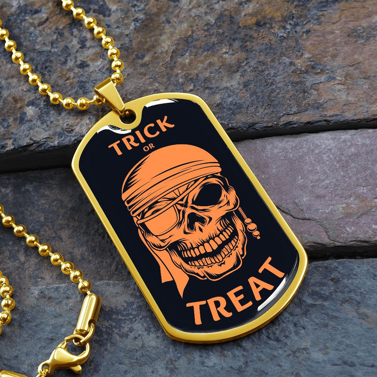 Trick or Treat pirate skull dog tag necklace with 18k gold finish on slate stone