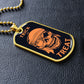 Gold-finish Trick or Treat pirate skull dog tag lying on black leather