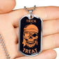 Silver Trick or Treat pirate skull dog tag held in an open hand to show its size